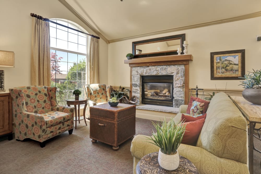 Elegant lounge seating with fireplace at Chancellor Gardens in Clearfield, Utah