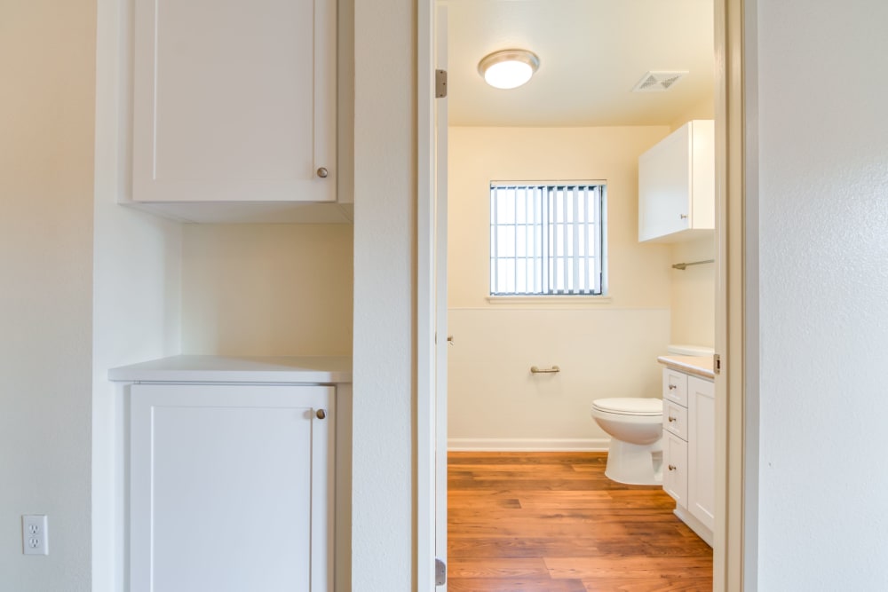 Storage and bathroom areas with wood floors in a home at Stuart Mesa in Oceanside, California