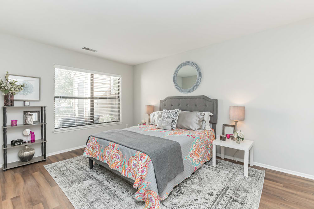 Spacious bedroom with wood flooring and big window at Eagle Rock Apartments at Columbia in Columbia, Maryland