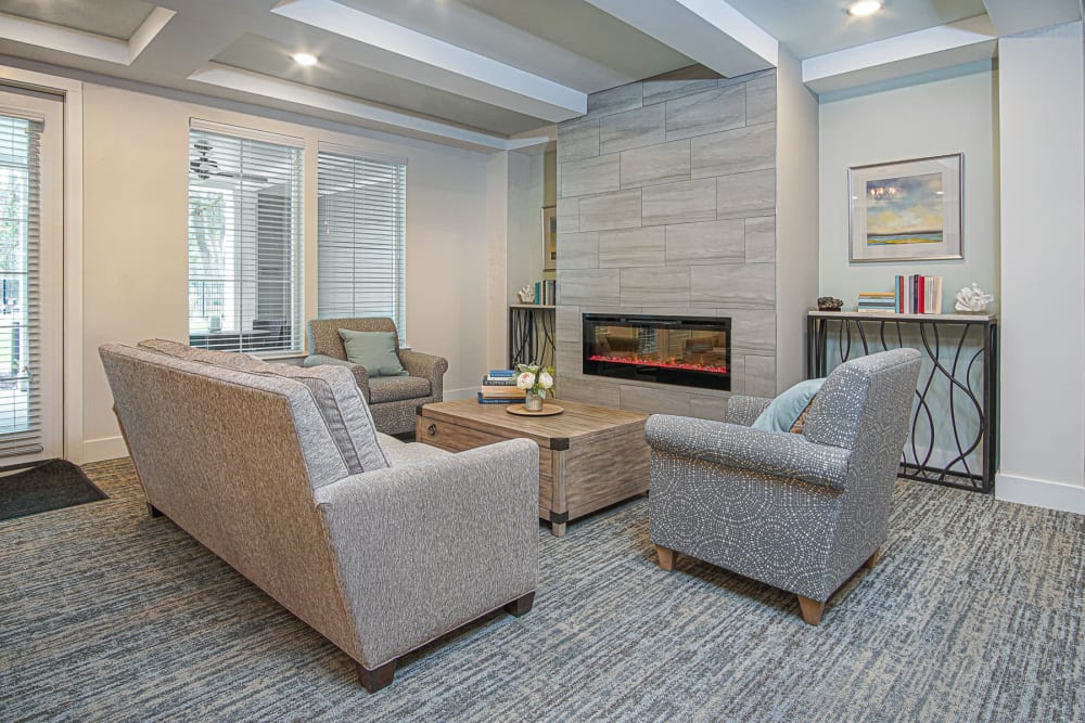 Lounge area in front of the fireplace in the lobby at Arcadia Senior Living Pace in Pace, Florida
