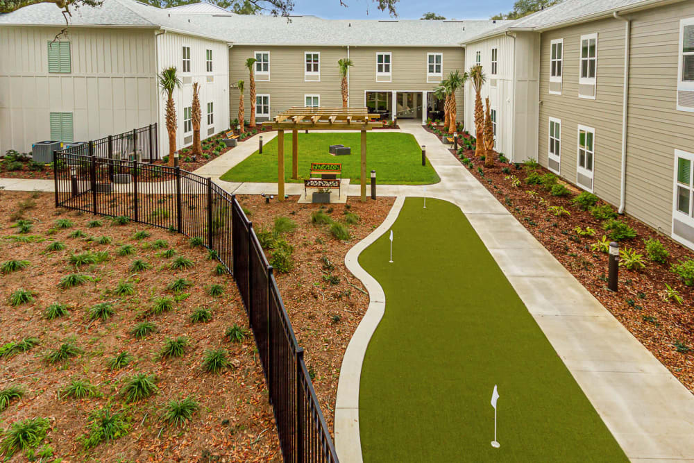 Putting green and well-maintained landscaping at Arcadia Senior Living Pace in Pace, Florida