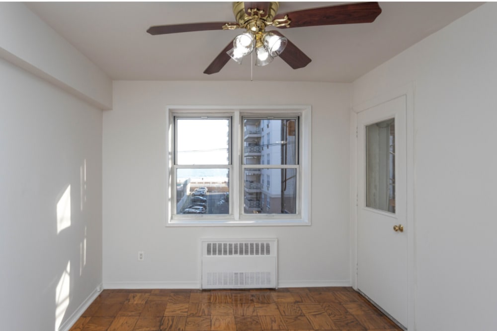 Cozy bedroom with a ceiling fan to stay cool on those warm days at Eastgold Long Island in Long Beach, New York