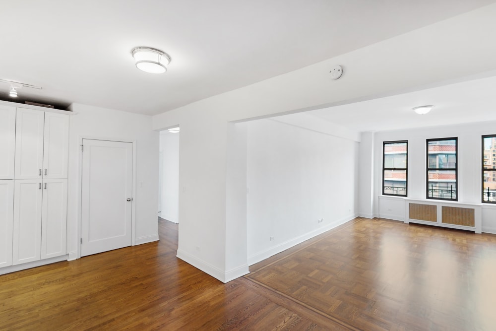 Very open and spacious living room area with large windows and lots of natural light at Eastgold NYC in New York, New York