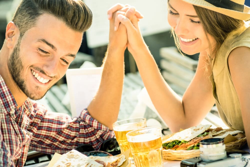 A nice couple out having drinks and enjoying a sunny day near Eastgold NYC in New York, New York