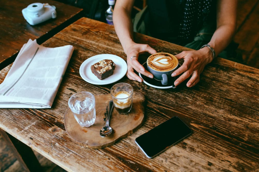 Resident studying at a trendy cafe near Eastgold NYC in New York, New York