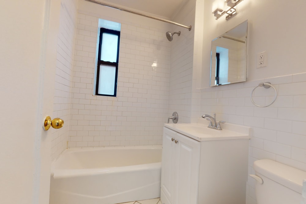 Small vanity and mirror in the bathroom at Eastgold NYC in New York, New York