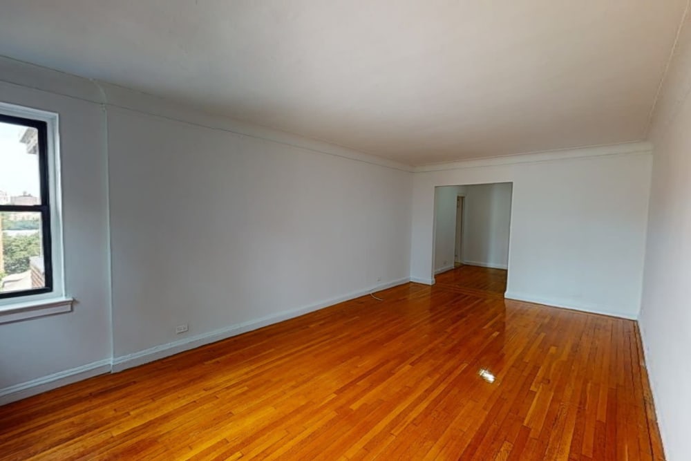 Shiny wood style flooring in a spacious room at Eastgold NYC in New York, New York
