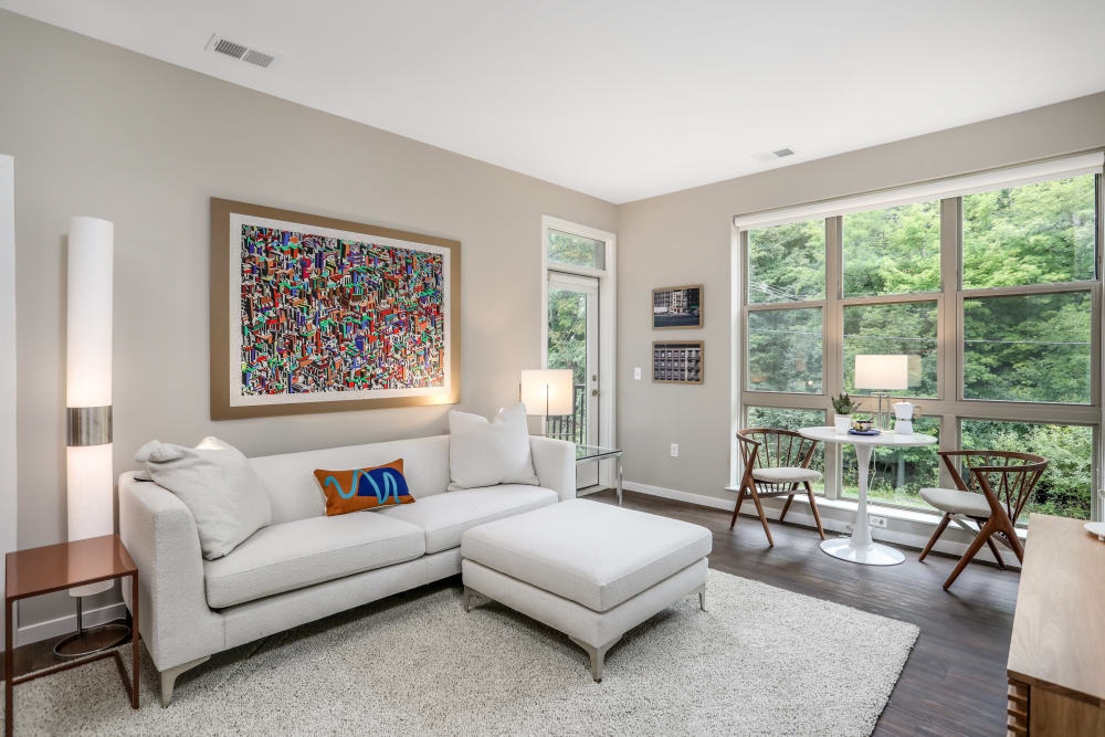 Model living space with a huge window at Town Court in West Bloomfield, Michigan