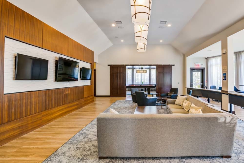 Community clubhouse interior with comfortable sitting area at The Grove Somerset in Somerset, New Jersey