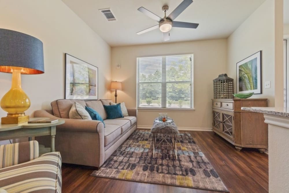 Model living room with ceiling fan at Auberge of Tyler in Tyler, Texas