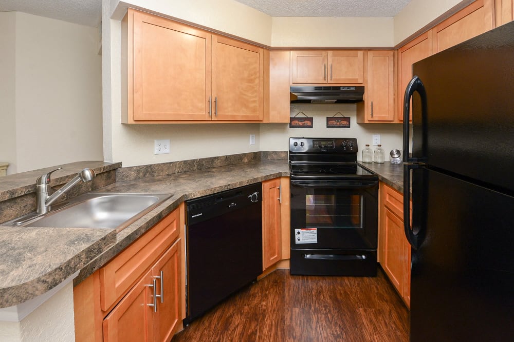 Kitchen with black appliance at Promenade Apartment Homes in Winter Garden, Florida