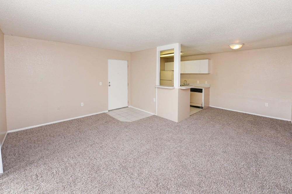 An open room with wall to wall carpeting in a home at Pointe Sienna Apartment Homes in Jacksonville, Florida