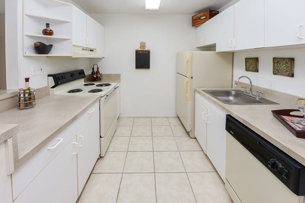 A kitchen with white cabinets in a home at Pointe Sienna Apartment Homes in Jacksonville, Florida