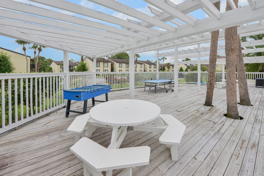 Sundeck with outdoor games at Pointe Sienna Apartment Homes in Jacksonville, Florida