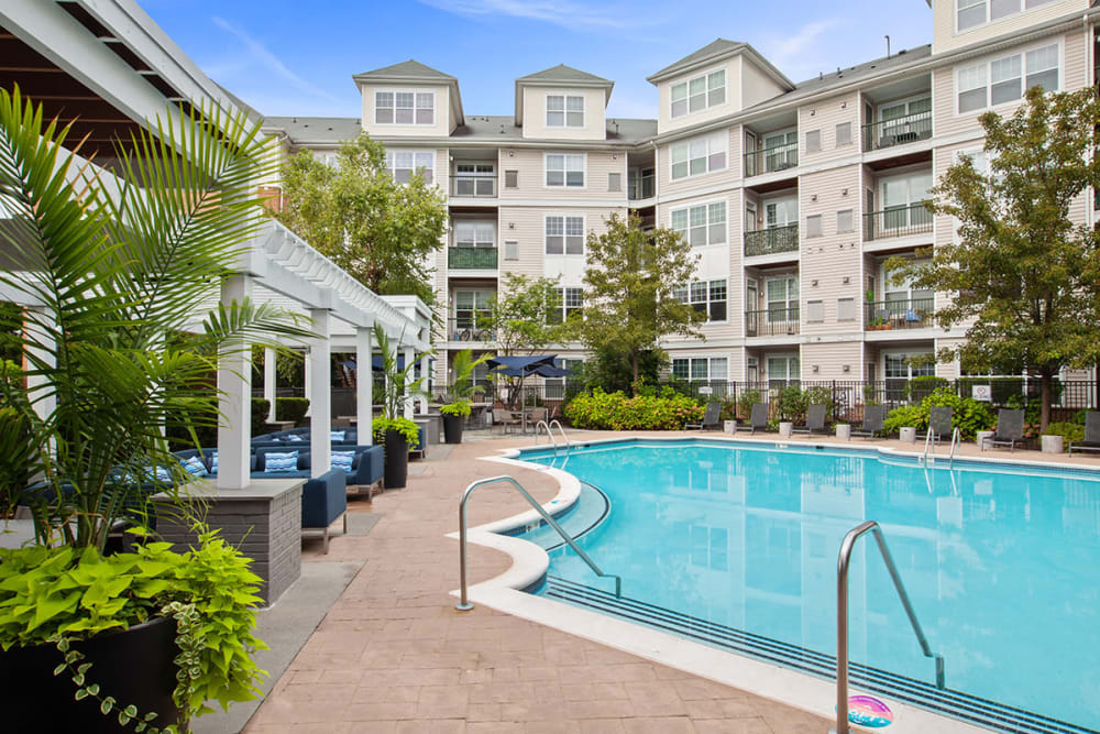 Resort style swimming pool with tons of seating to relax next to the pool at Sofi Lyndhurst in Lyndhurst, New Jersey