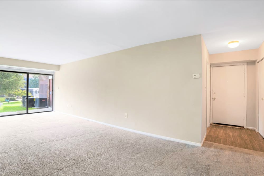 Apartment's spacious living area with a sliding door to the private patio outside at Eagle Rock Apartments at Towson in Towson, Maryland
