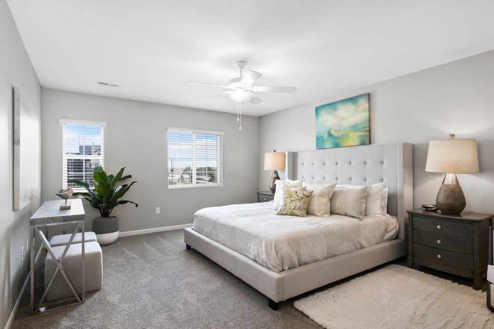 Large bedroom with wood style flooring and a nice ceiling fan at BB Living Murphy Creek in Aurora, Colorado