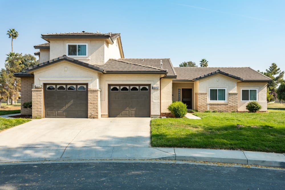 Exterior view of a home with two garage doors at Constellation Park in Lemoore, California