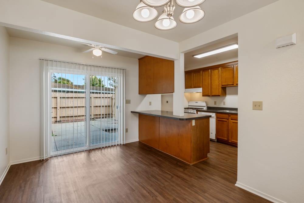 Dining area with wood floors and view of backyard in a home at Bruns Park in Port Hueneme, California
