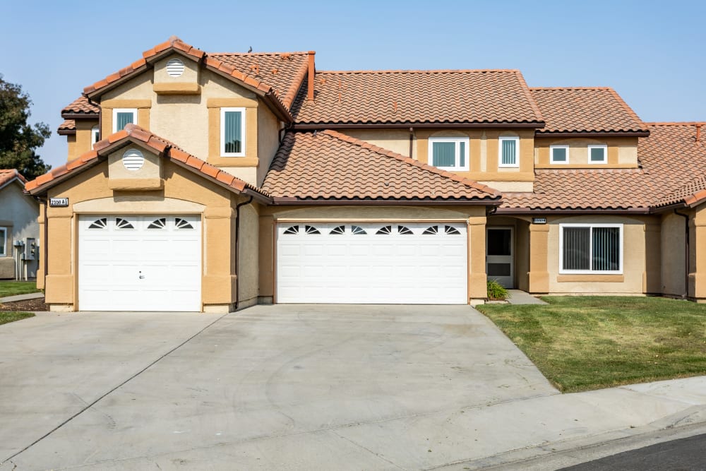 Exterior view of a home with two garage doors at Coral Sea Park in Lemoore, California