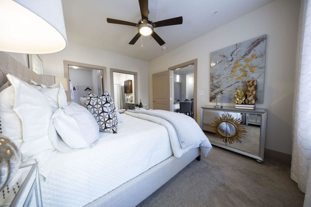 Model bedroom with a walk-in closet and ensuite bathroom at Steelyard in Oklahoma City, Oklahoma