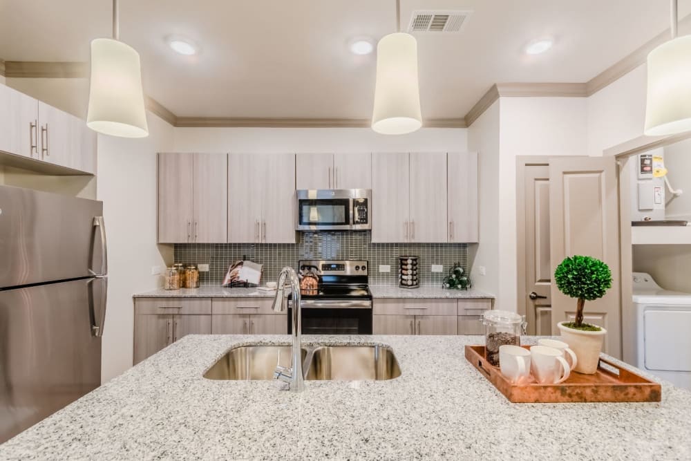 Stone-top surfaces in the kitchens at Atlas Point at Prestonwood in Carrollton, Texas