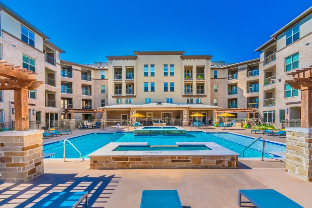 Beautiful pool and patio for residents to relax at Atlas Point at Prestonwood in Carrollton, Texas