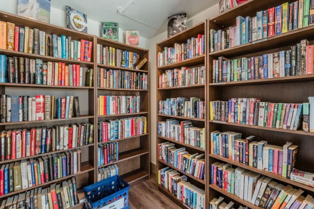Library with various full bookshelves at Atlas Point at Prestonwood in Carrollton, Texas
