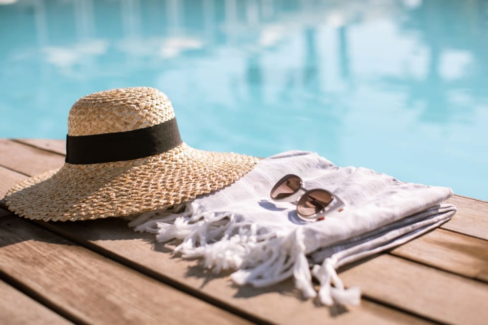 a pair of sunglasses and a hat by the pool at Adobe Flats II in Twentynine Palms, California