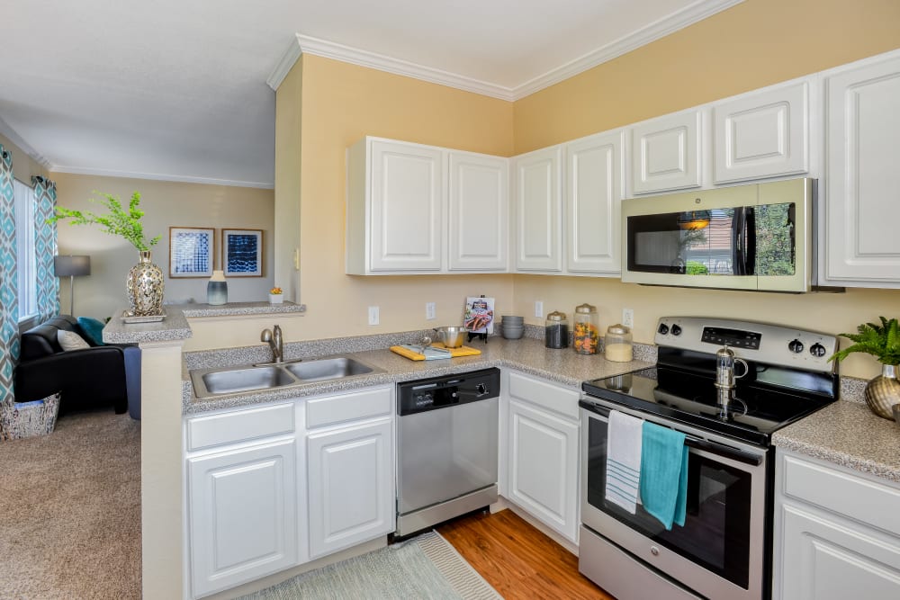 Kitchen with white cabinets and stainless-steel appliances at Dove Valley Apartments in Englewood, Colorado
