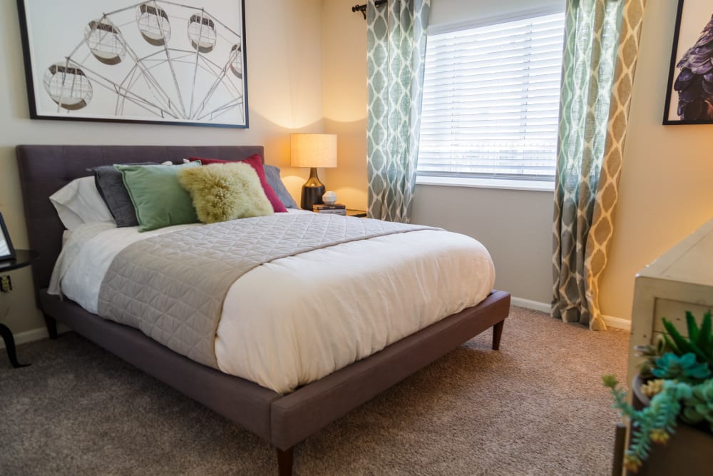 Bedroom with a lamp at Metro on 5th in Saint Charles, Missouri