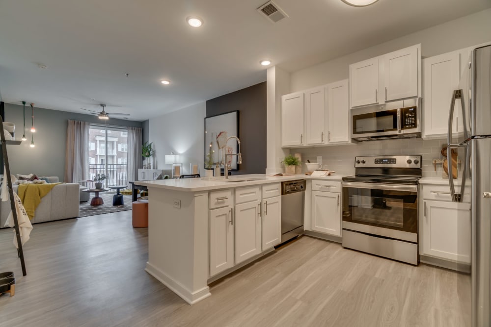 Very open kitchen and living area with a breakfast bar at The Flats at West Broad Village in Glen Allen, Virginia