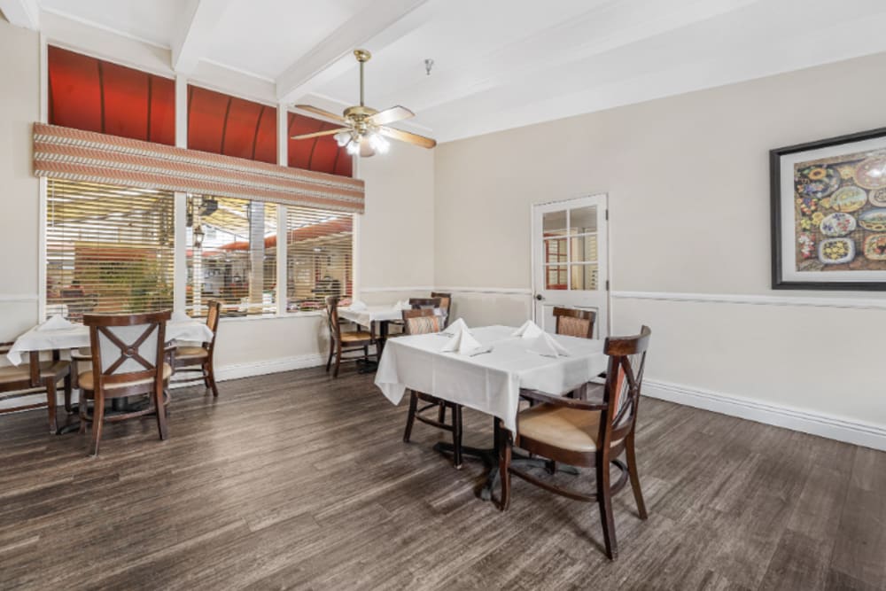 Dining area near large windows at Meridian at Ocean Villa & Bella Mar in Santa Monica, California