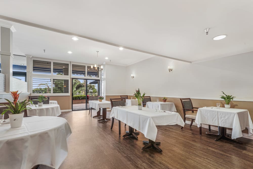 Community dining area with wood style floors at Meridian at Ocean Villa & Bella Mar in Santa Monica, California