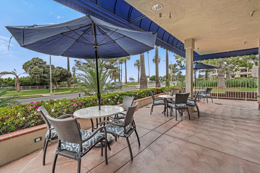 Covered patio surrounded by flowers at Meridian at Ocean Villa & Bella Mar in Santa Monica, California