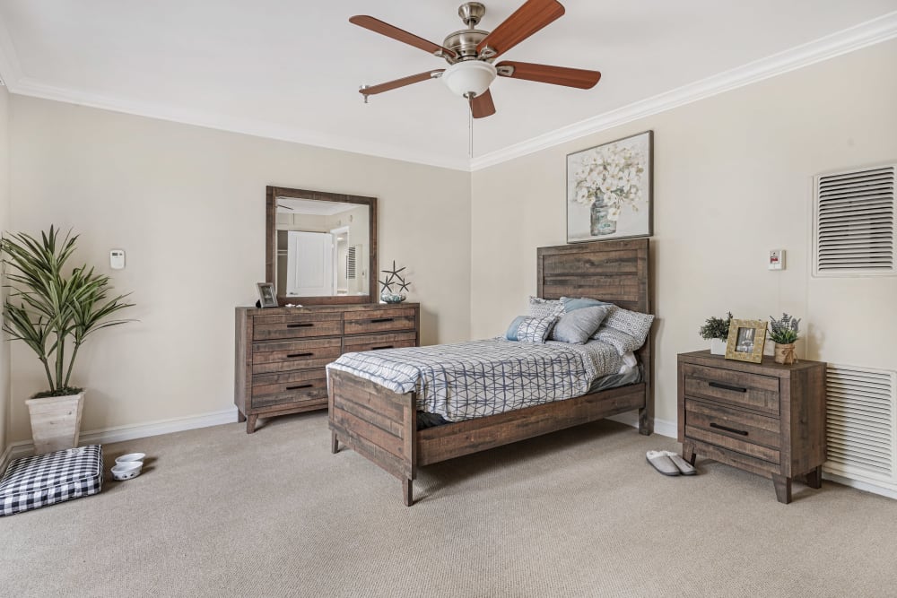 Large bedroom with wood style furniture and a ceiling fan at Meridian at Ocean Villa & Bella Mar in Santa Monica, California