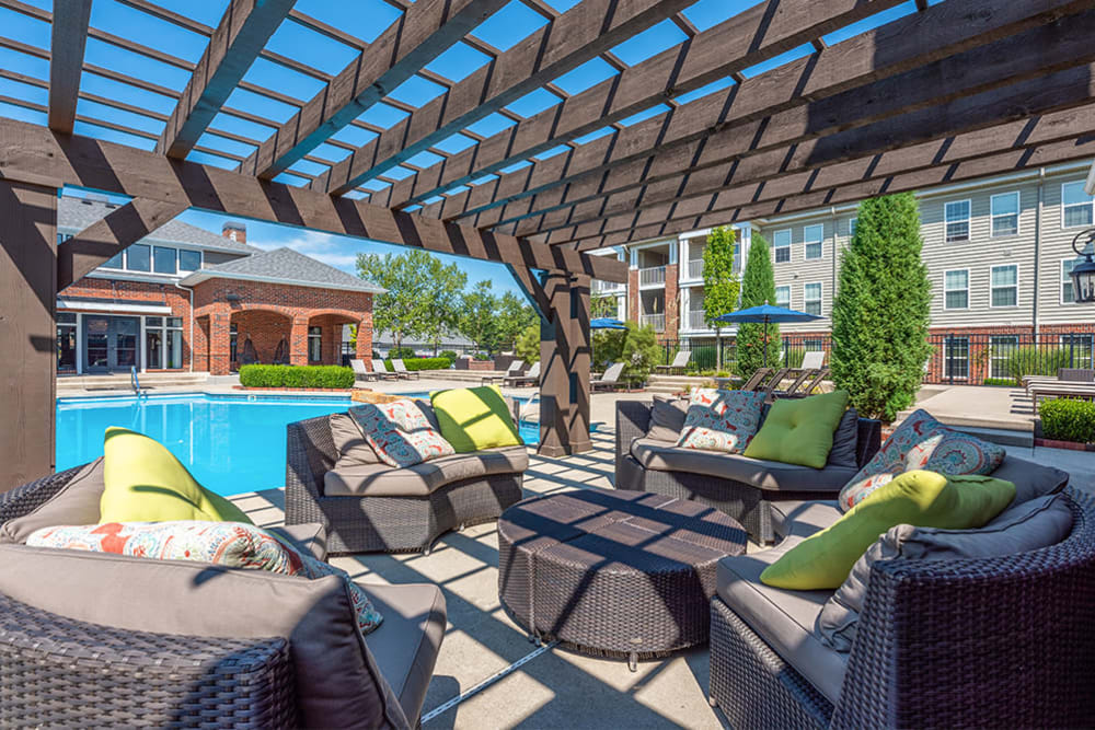 Outdoor lounge area next to pool at Clifton Park Apartment Homes in New Albany, Ohio