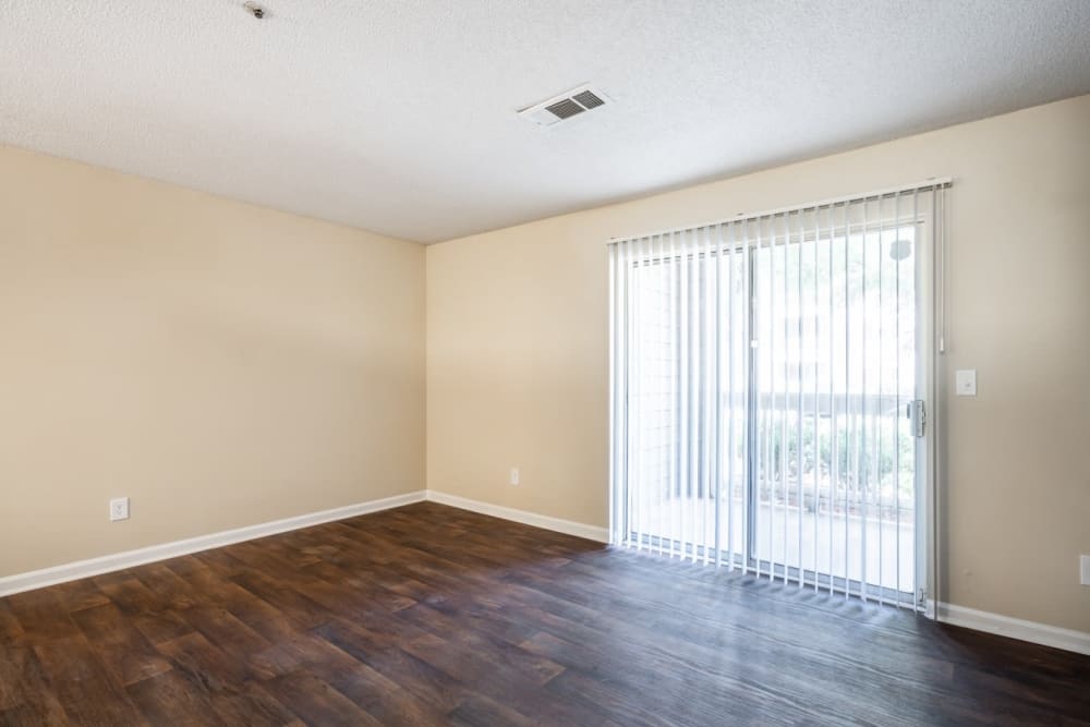 Large living room with wood-style laminate at Lake Crossing in Austell, Georgia