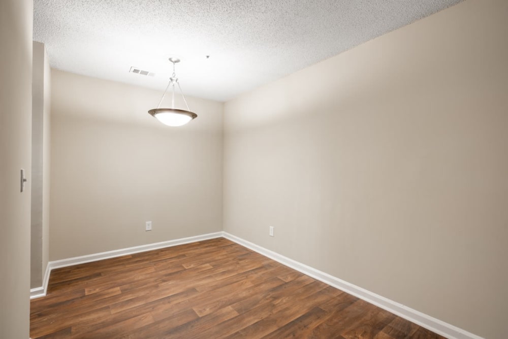Dining room with wood-style laminate flooring at Lake Crossing in Austell, Georgia