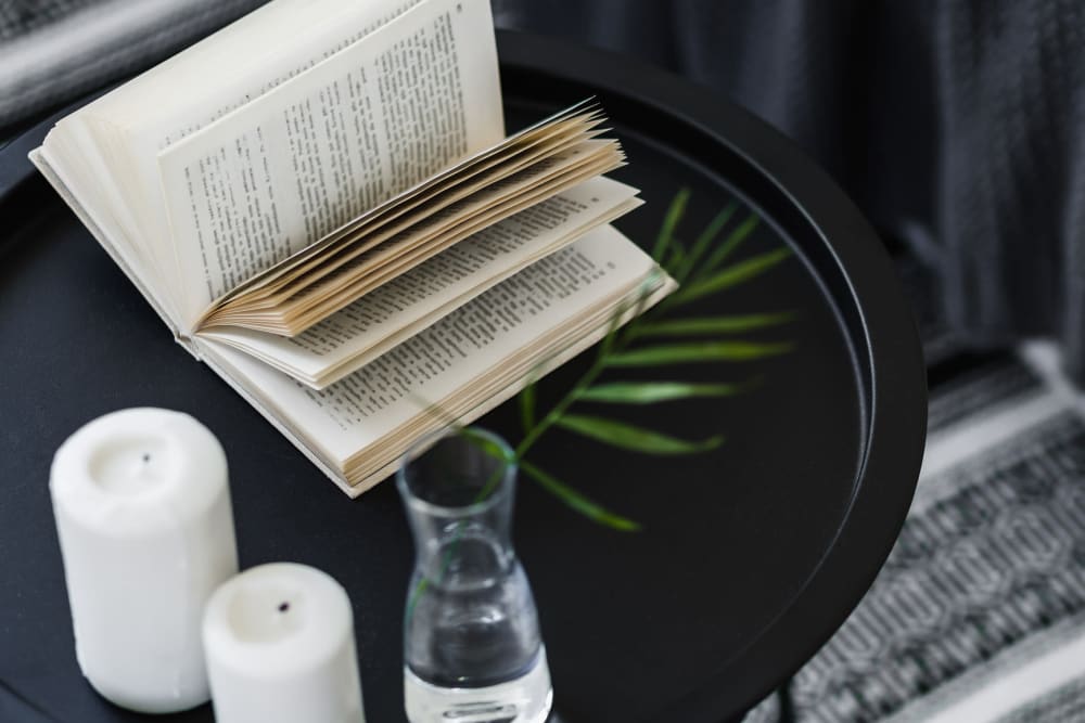 Close up of a book and candles on a table in a Morgan Properties home