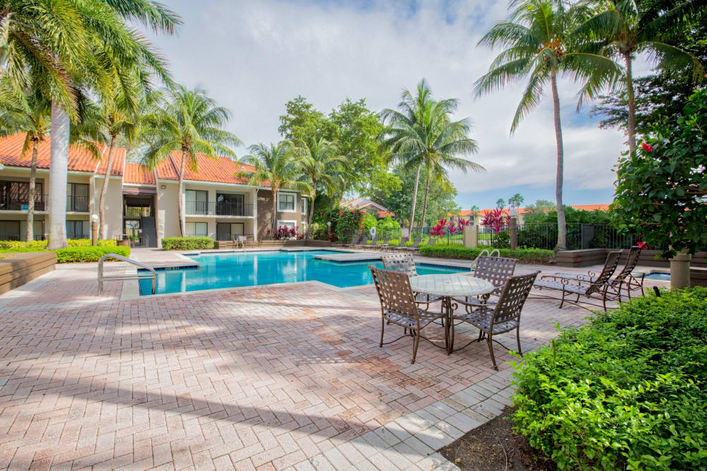 Outdoor lounge area and ping pong table at Village Place Apartment Homes in West Palm Beach, Florida