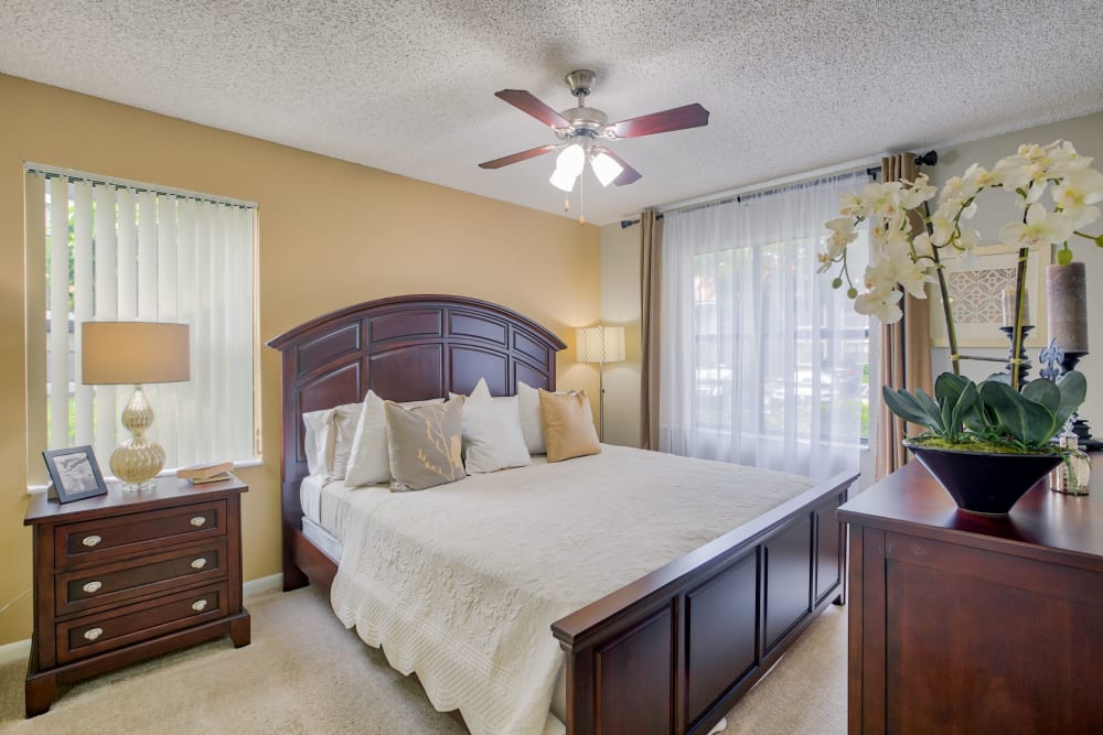 Spacious model bedroom with plush carpeting at Village Place Apartment Homes in West Palm Beach, Florida