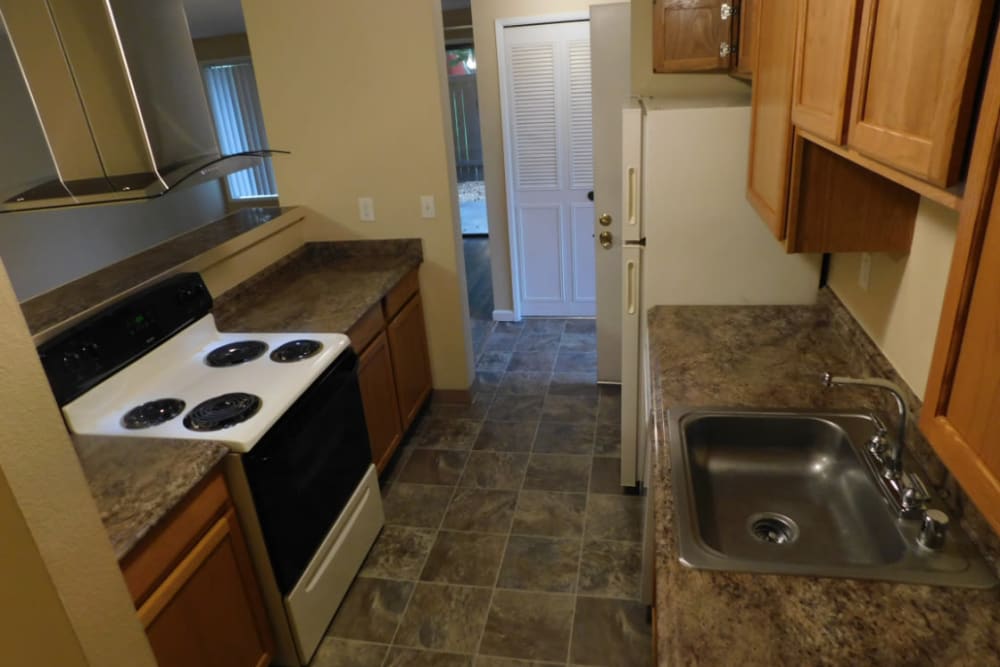 Kitchen with an electric stove at Oakbrook Apartments in Vancouver, Washington