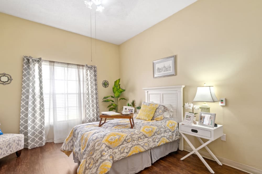 Bedroom with wood style floors at Truewood by Merrill, Bradenton in Bradenton, Florida