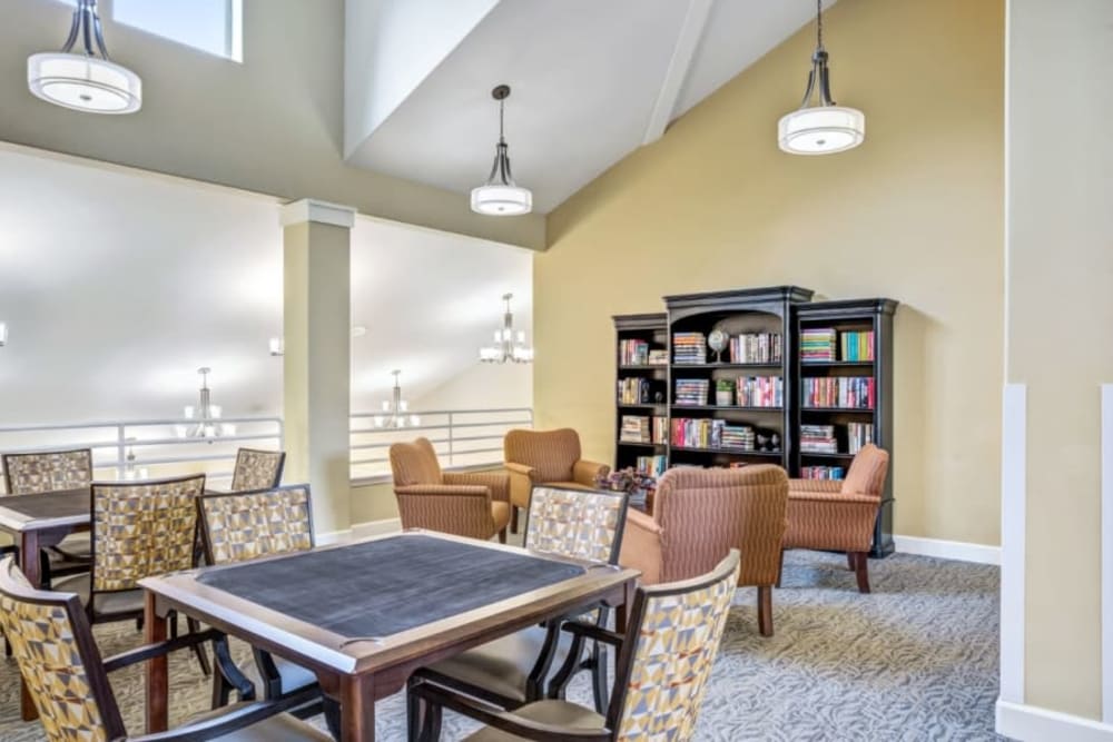 Reading and game area with seating at Woodside Senior Living in Springfield, Oregon