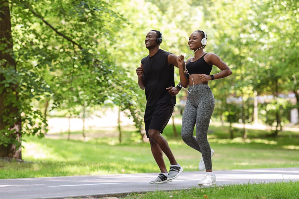 Resident couple out for a morning jog through the verdant neighborhood at Vantage Park Apartments in Seattle, Washington