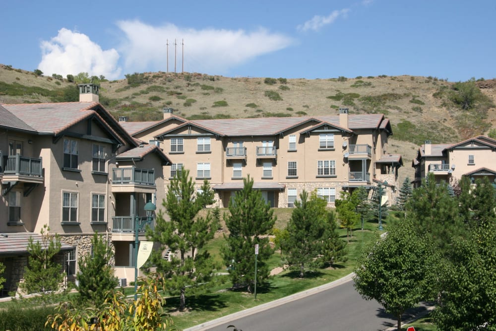 Exterior of Montrachet Apartment Homes with plenty of mature trees in Lakewood, Colorado