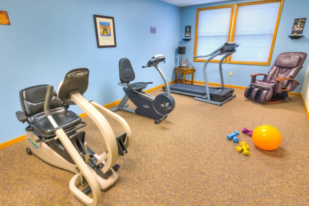 Physical therapy room with massage chair and exercise equipment at Addington Place of Fairfield in Fairfield, Iowa