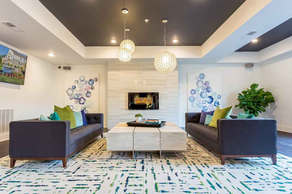 Clubhouse seating area in front of a fireplace at Creekside at Greenlawn Apartment Homes in Columbia, South Carolina