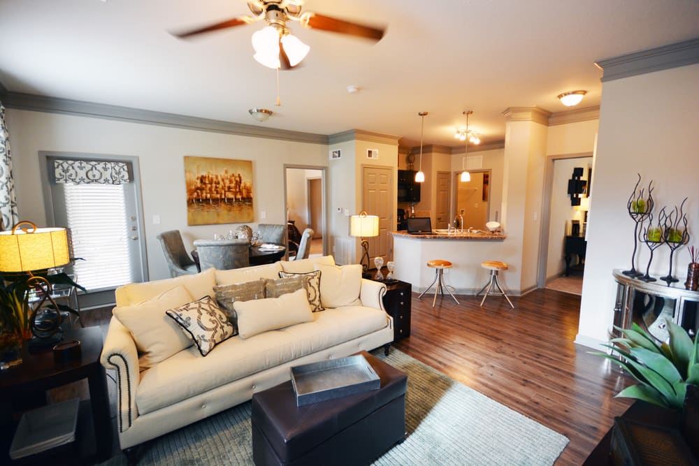 Open concept living room, dining area, and kitchen in a model home at Estates at McDonough Apartment Homes in McDonough, Georgia